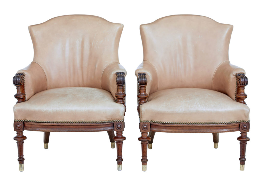 PAIR OF LATE 19TH CENTURY CARVED WALNUT AND LEATHER ARMCHAIRS