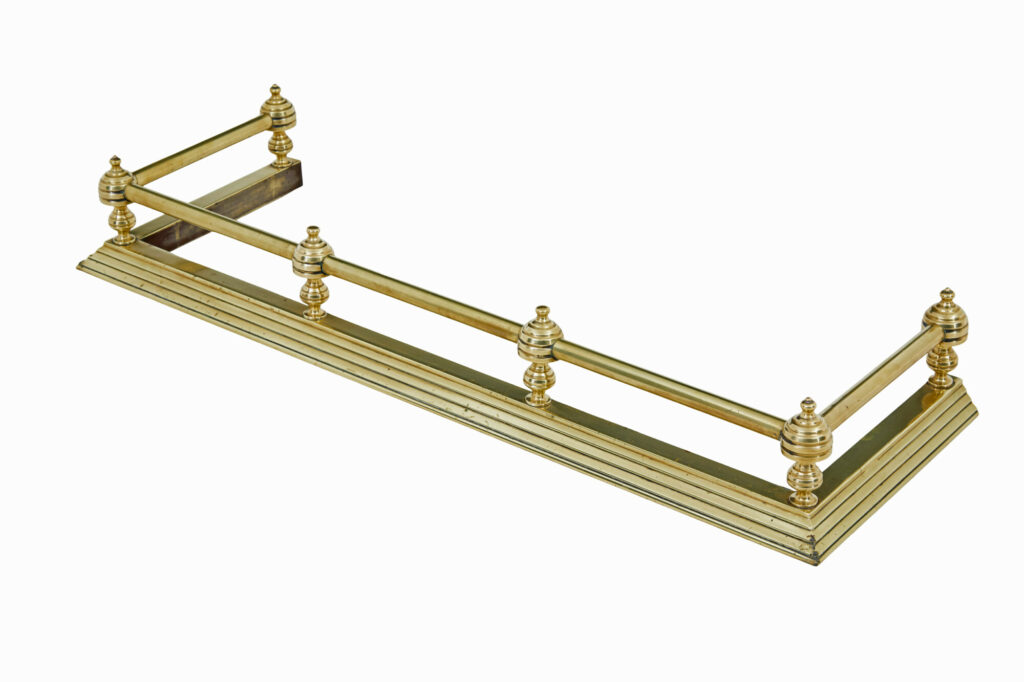 EARLY 20TH CENTURY BRASS FIRESIDE FENDER